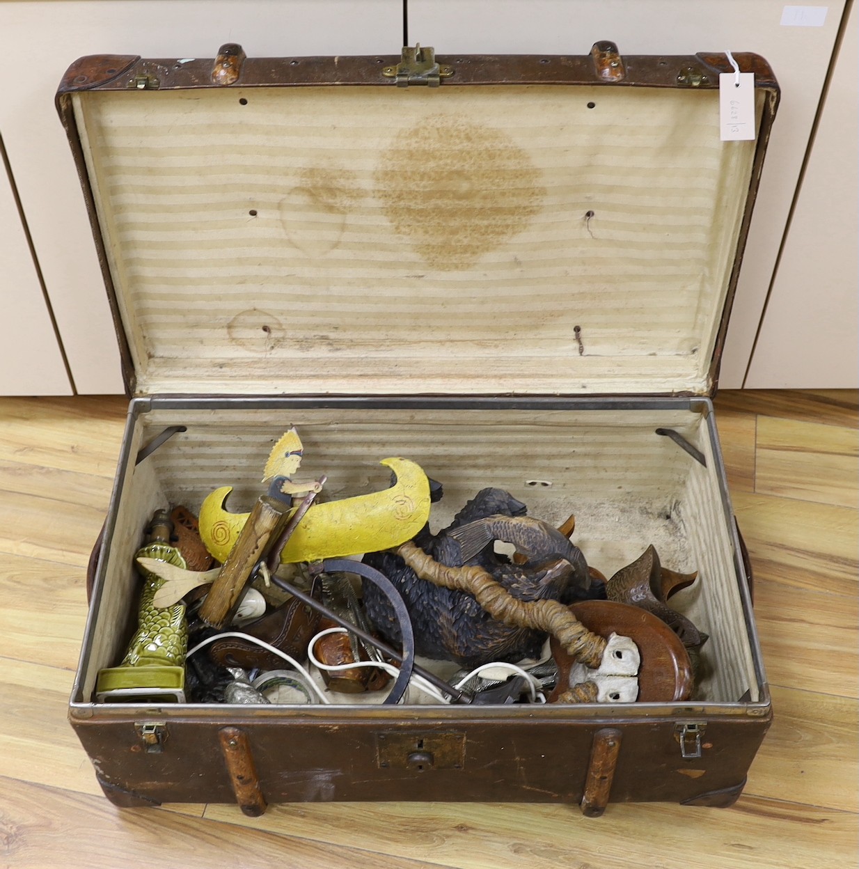 A trunk of various collectables including a Japanese carved wood bear, mounted antlers, other carvings etc.